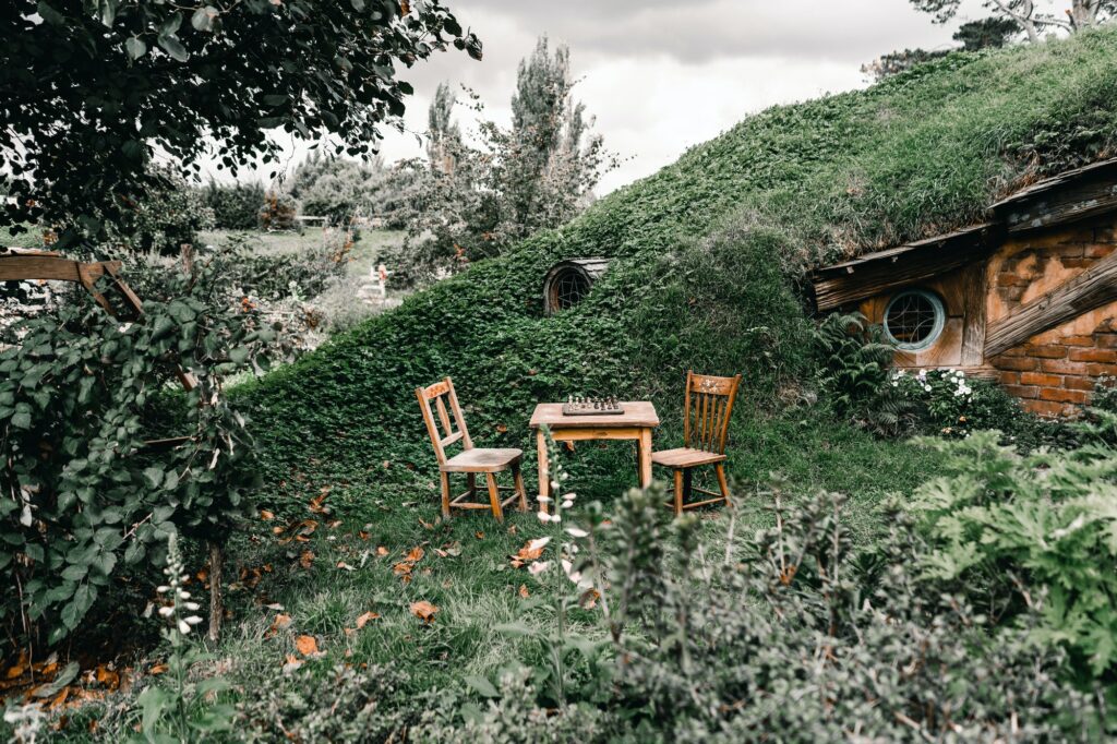 Chess table and chairs near hobbit dwelling